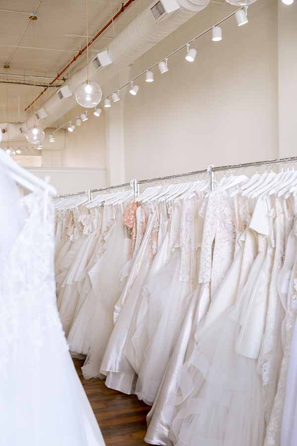 racks with wedding dresses